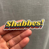 A vibrant, multicolored Shabbat sticker held up in real size, showcasing its fun and expressive design. Perfect for celebrating the joy, holiness, and spiritual beauty of Shabbat in Jewish tradition.






